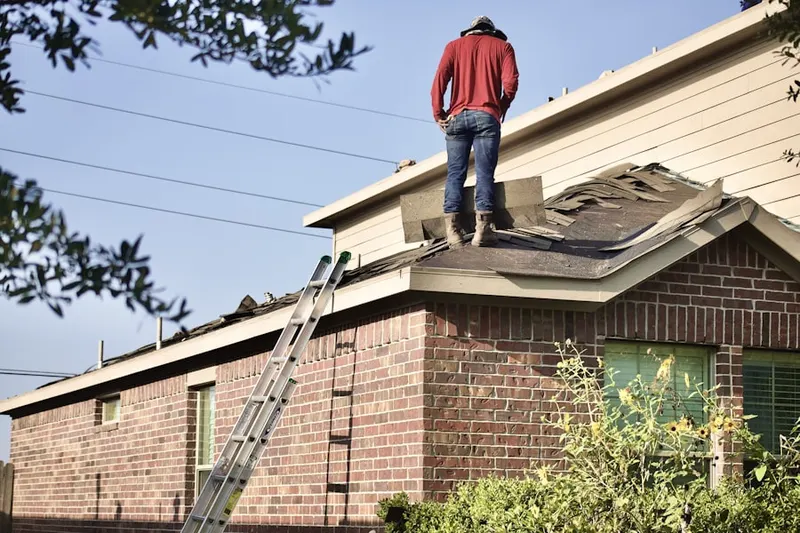Professional roofer working on a residential roof in Stoutsburg